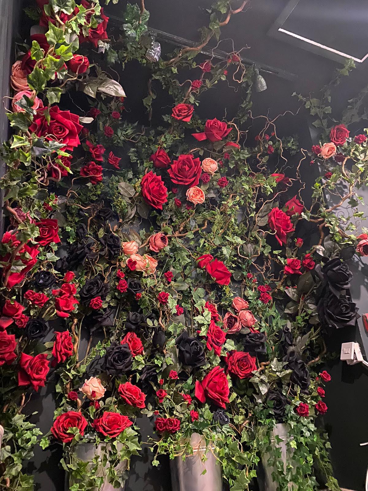 red rose wall decor with green leaf